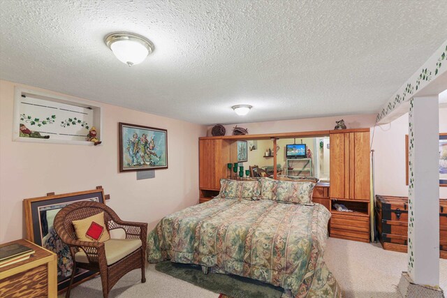 carpeted bedroom with a textured ceiling