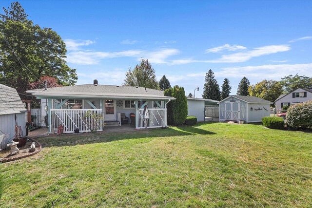 back of property featuring a storage shed, a porch, and a yard