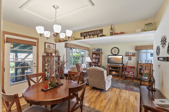 dining area featuring an inviting chandelier and hardwood / wood-style floors