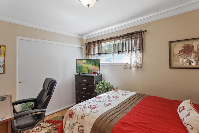 bedroom with hardwood / wood-style floors and crown molding