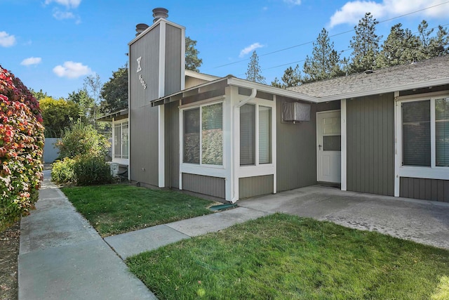 view of property exterior with a yard