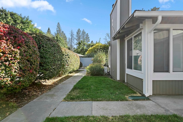 view of side of home with a lawn