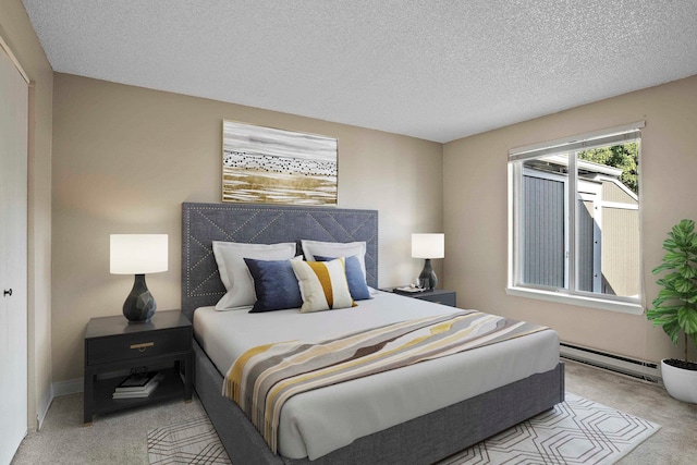 bedroom featuring light carpet, a textured ceiling, and a baseboard heating unit