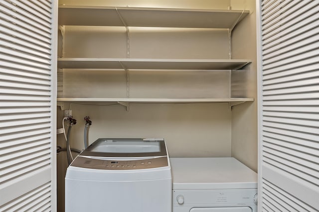 clothes washing area featuring independent washer and dryer