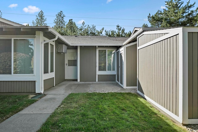 rear view of property featuring a lawn