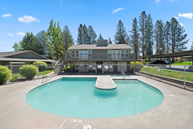 view of swimming pool with a patio and a deck