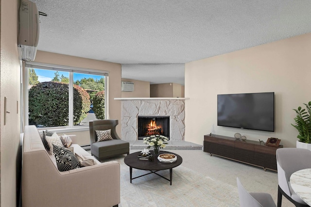 living room with light colored carpet, a textured ceiling, a fireplace, and an AC wall unit