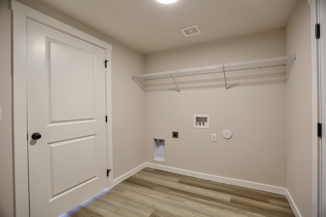 laundry area featuring washer hookup, hookup for an electric dryer, and light wood-type flooring