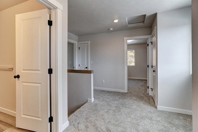 hallway with light colored carpet