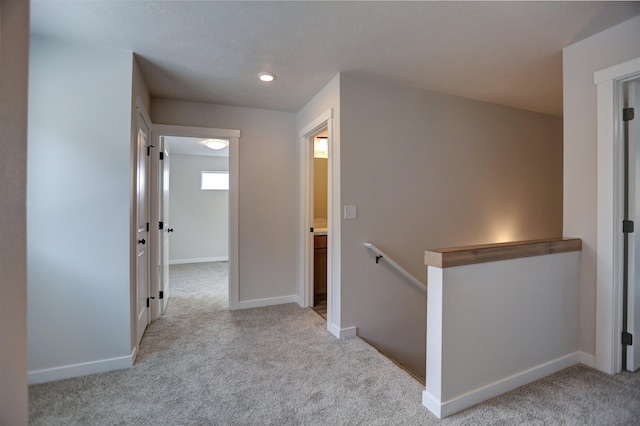 hallway featuring light carpet