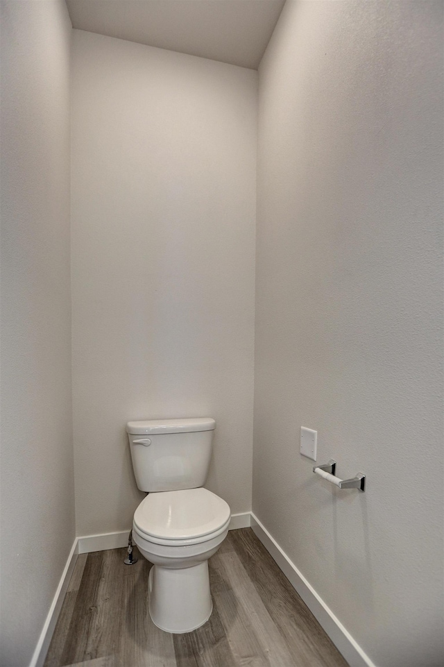 bathroom featuring hardwood / wood-style floors and toilet