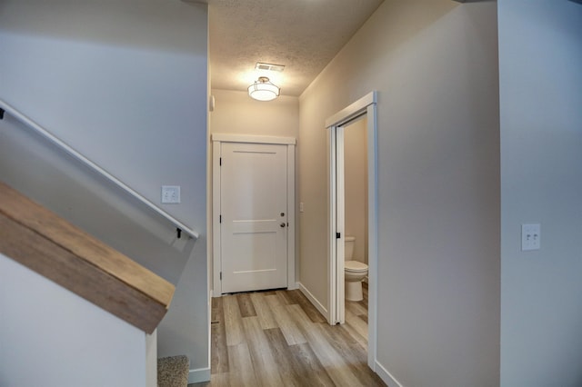 interior space with light hardwood / wood-style floors and a textured ceiling