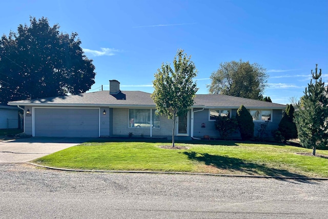 ranch-style home featuring a garage and a front lawn