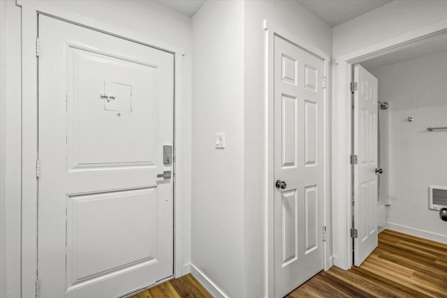 doorway with hardwood / wood-style flooring and a textured ceiling