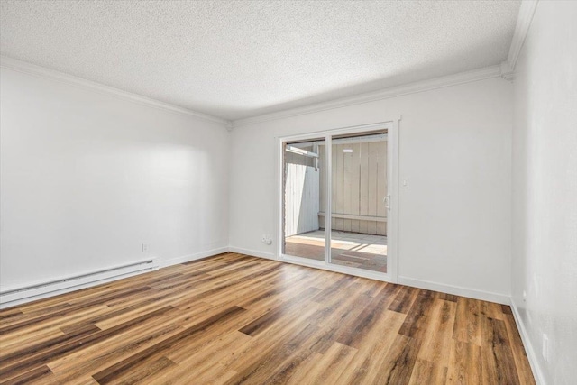 spare room featuring a textured ceiling, ornamental molding, hardwood / wood-style floors, and a baseboard radiator