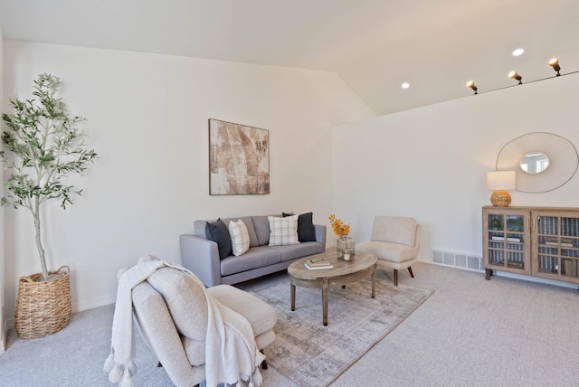 living room featuring light colored carpet and lofted ceiling