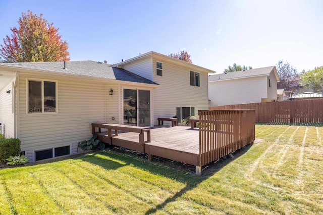 rear view of house featuring a lawn and a wooden deck