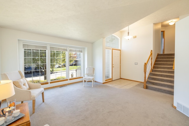 unfurnished room with light carpet and a textured ceiling