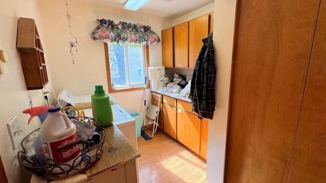 bathroom featuring washer / dryer and hardwood / wood-style flooring