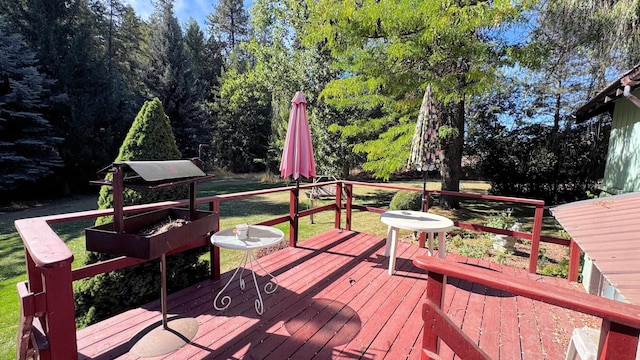 wooden deck with a lawn