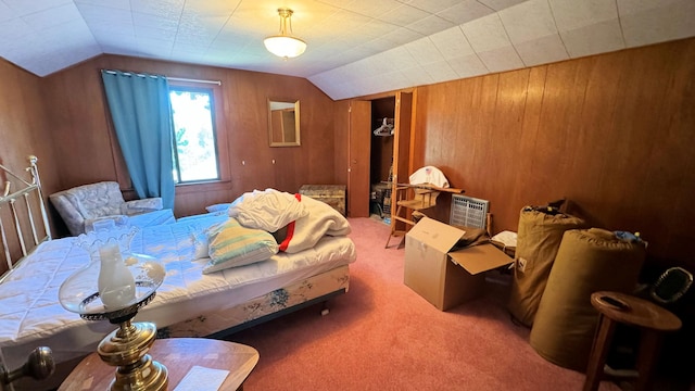 carpeted bedroom featuring wooden walls and vaulted ceiling