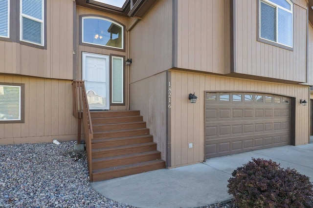 doorway to property with a garage