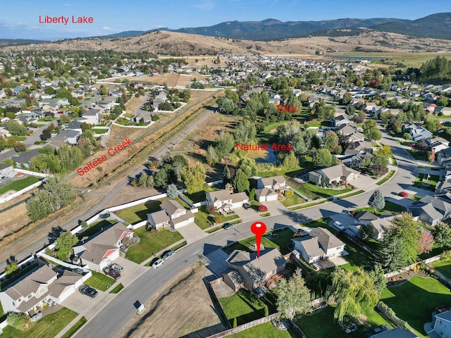 birds eye view of property featuring a mountain view