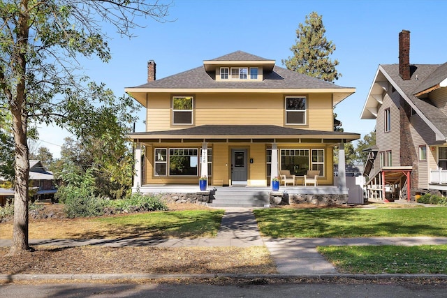 view of front of home with a front yard and covered porch