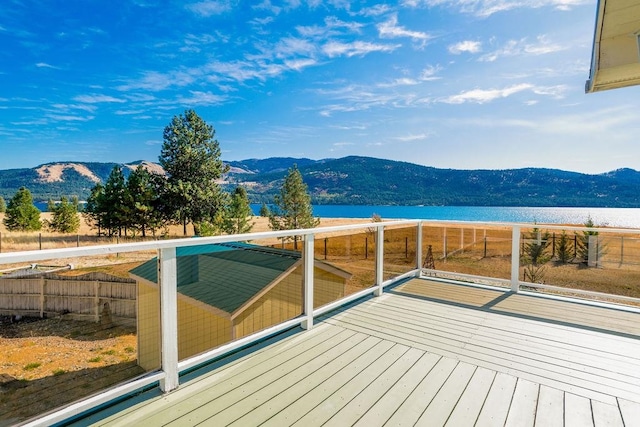 wooden deck featuring a water and mountain view