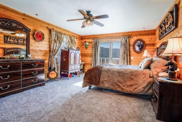 bedroom featuring wood walls, ceiling fan, and carpet