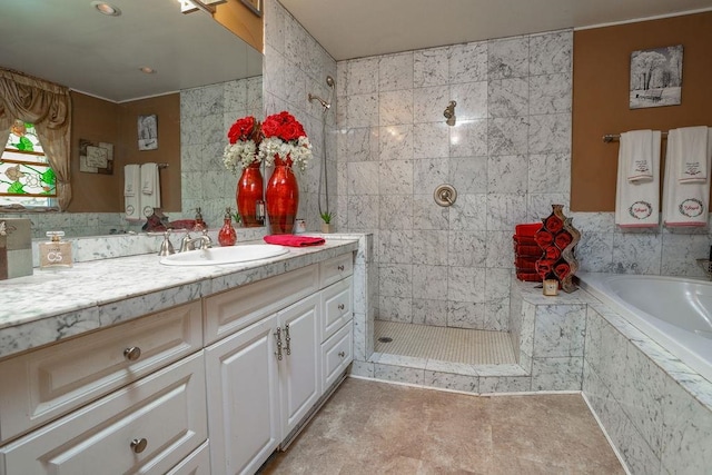 bathroom with tile walls, separate shower and tub, and vanity