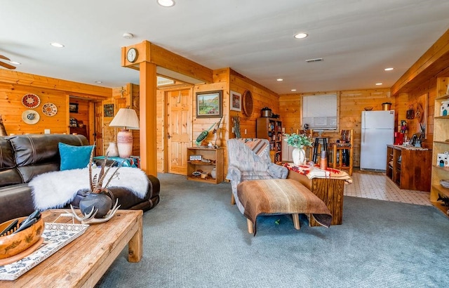 living room with wooden walls and carpet