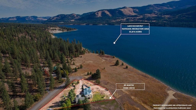 bird's eye view with a water and mountain view