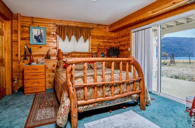 carpeted bedroom featuring a mountain view, access to exterior, and multiple windows