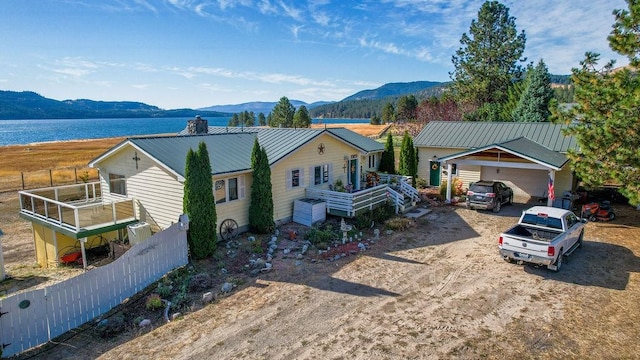 ranch-style home with a garage and a water and mountain view