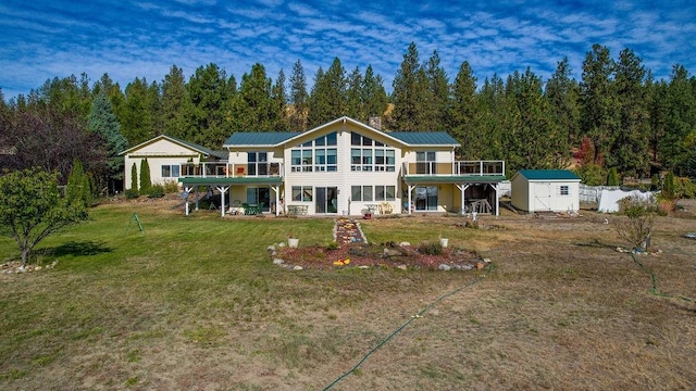 rear view of house with a storage unit and a lawn