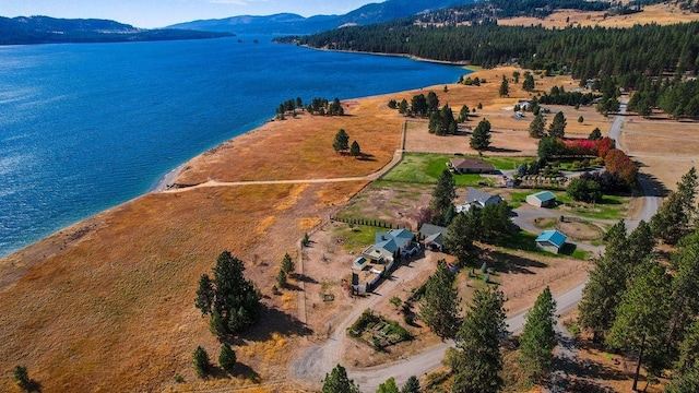 drone / aerial view featuring a water and mountain view