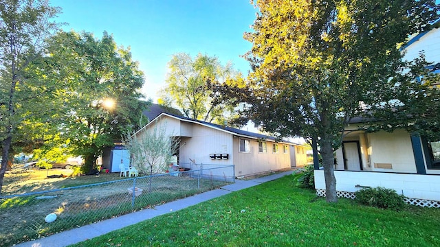 view of side of home with a yard