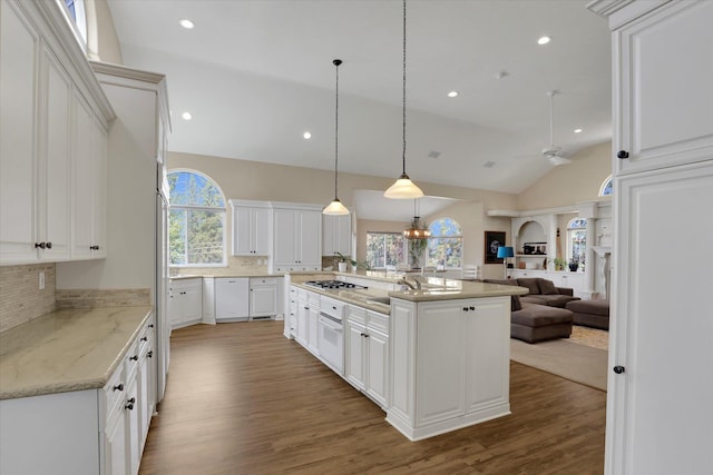 kitchen featuring vaulted ceiling, dark wood-type flooring, white cabinetry, and a healthy amount of sunlight