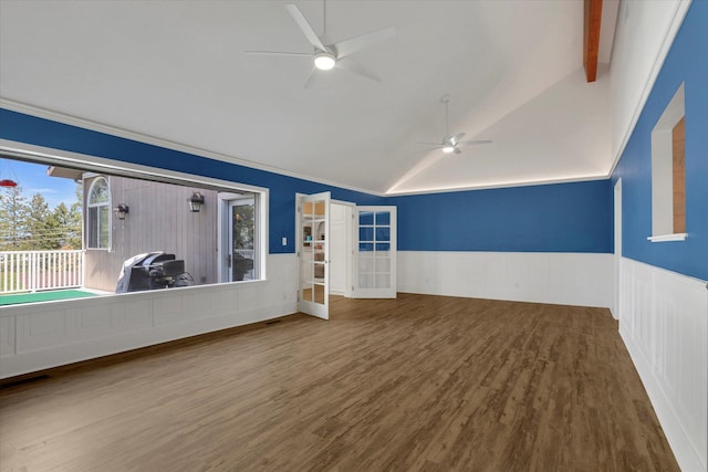 spare room with ceiling fan, vaulted ceiling with beams, and hardwood / wood-style floors