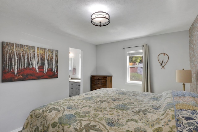 bedroom with ensuite bath and a textured ceiling