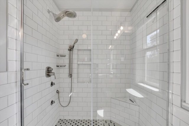 bathroom featuring a shower with shower door