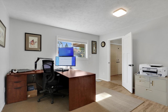 office space featuring light hardwood / wood-style floors and a textured ceiling