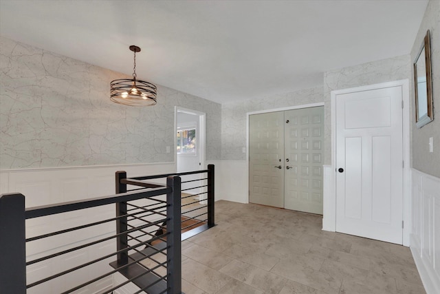 hallway featuring an inviting chandelier