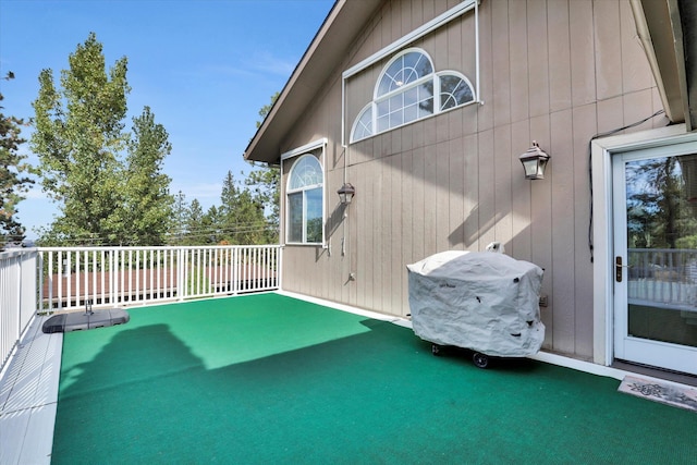 wooden terrace featuring grilling area