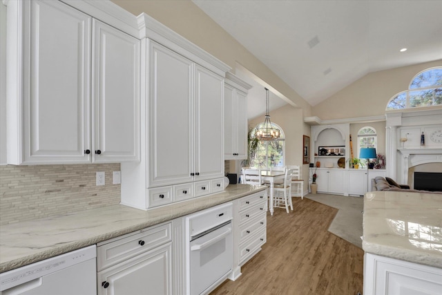 kitchen featuring hanging light fixtures, white cabinetry, white appliances, lofted ceiling, and light hardwood / wood-style flooring