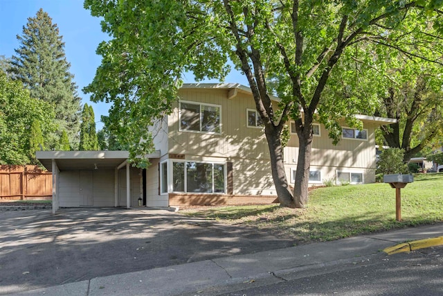 view of front of property with a front lawn and a carport