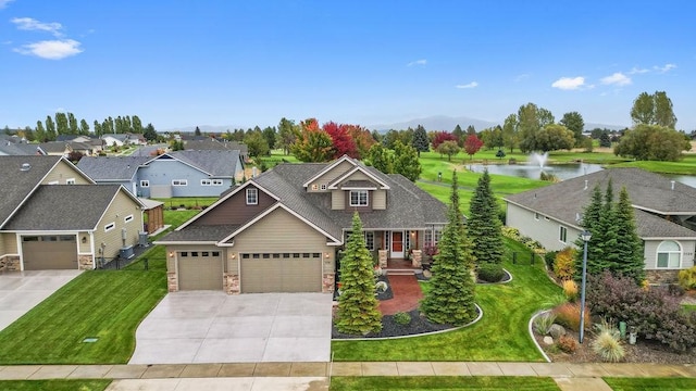 craftsman inspired home featuring a front yard and a water view