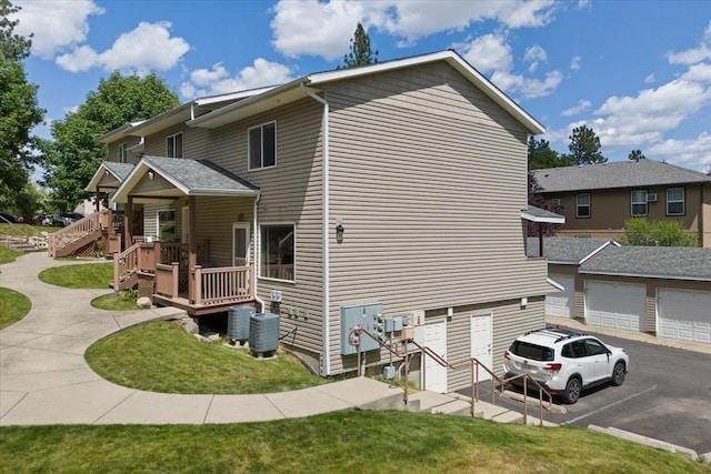 view of side of property with a garage and a yard