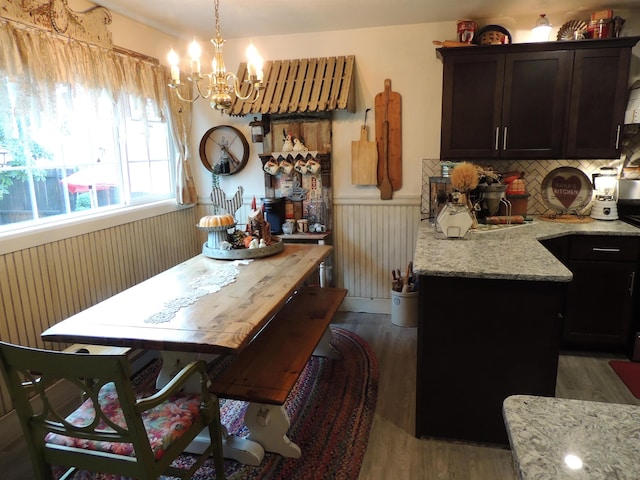 dining space featuring a notable chandelier and dark hardwood / wood-style flooring